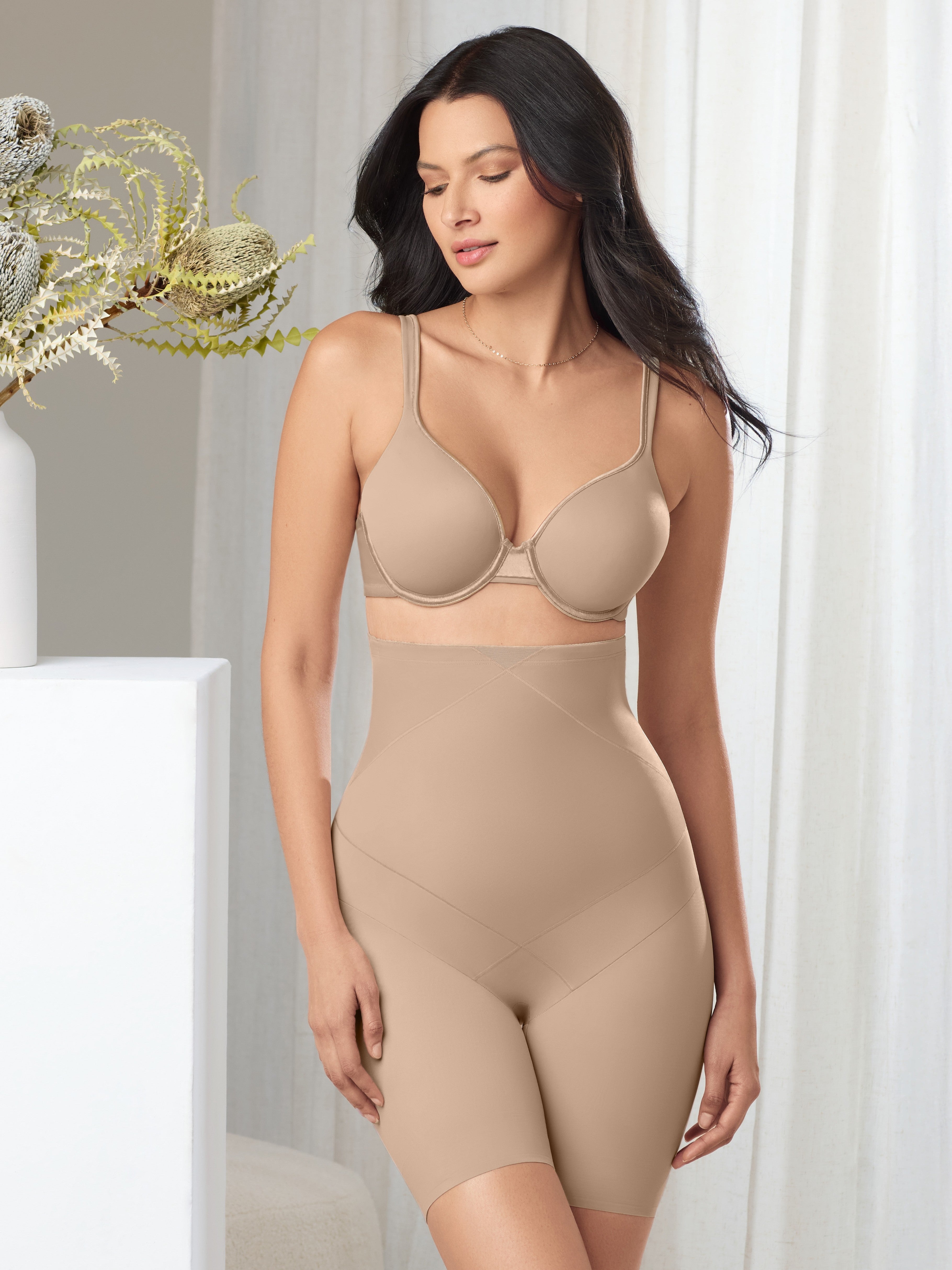 a woman wearing a nude high waisted tummy control panty short
