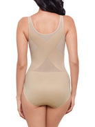a woman wearing a nude shaping bodysuit body shaper