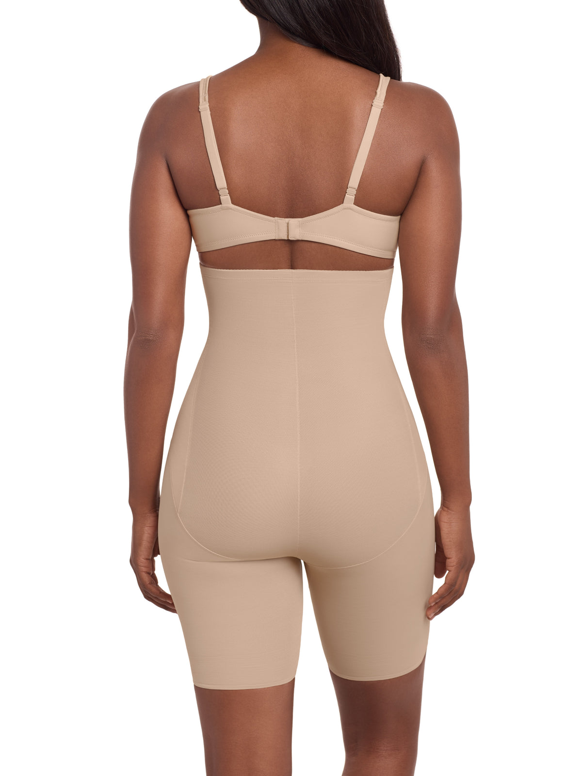 a woman wearing a beige high waisted tummy control thigh slimmer shaping short miraclesuit shapewear