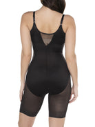 a woman wearing a black open bust torsette body shaper sheer shapewear