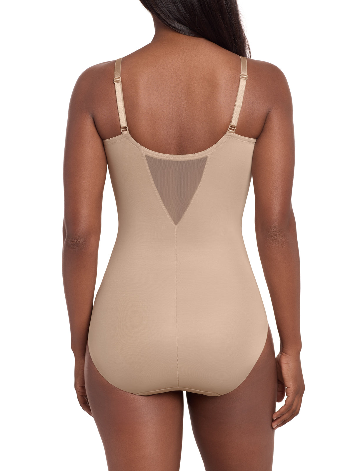 a woman wearing a beige tummy control shaping bodysuit miraclesuit shapewear body shaper sheer shapewear
