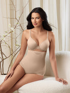 a woman sitting on a chair wearing nude high waisted tummy control underwear sheer shapewear all-groups