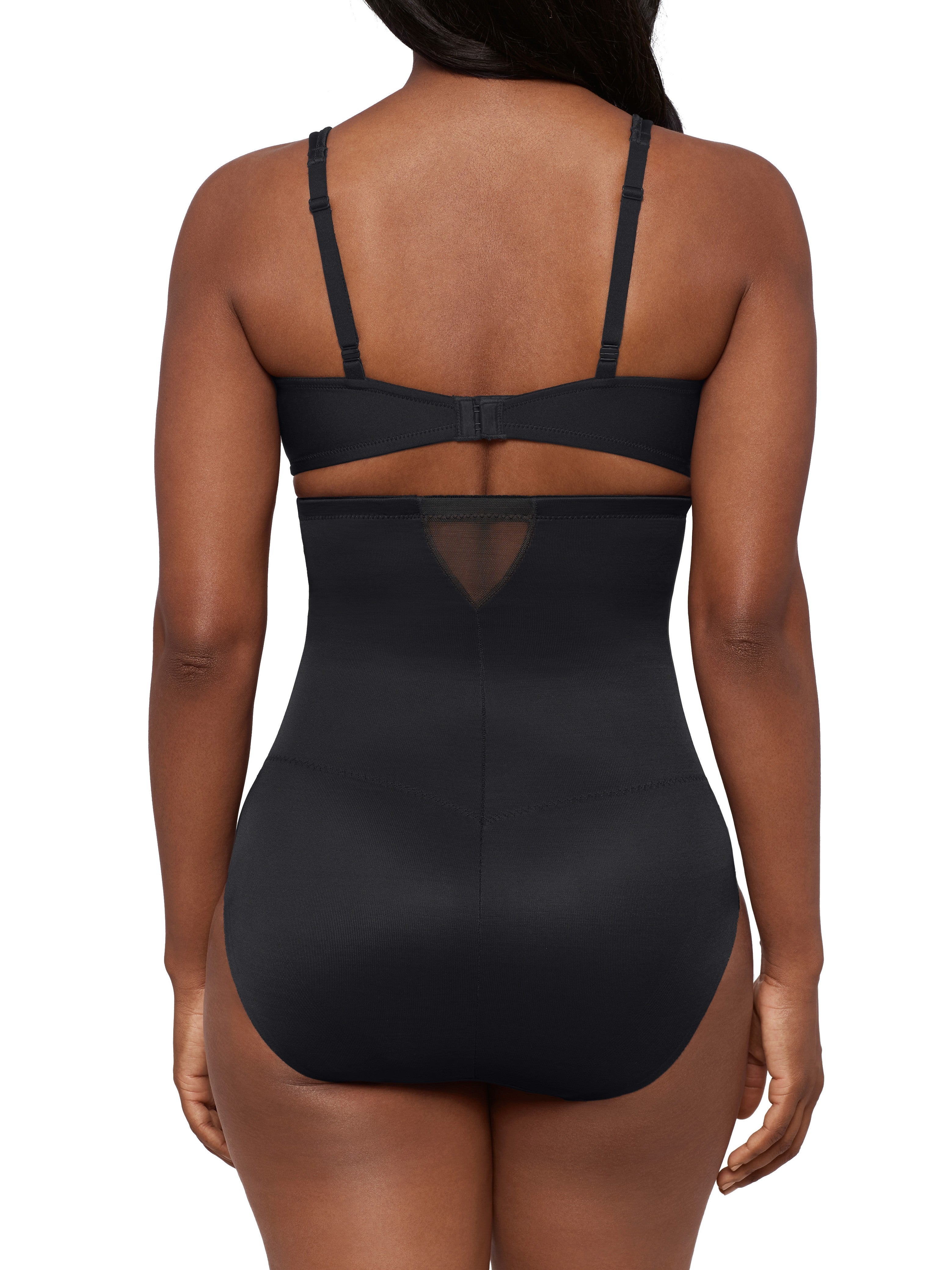 a woman wearing black high waisted sheer shapewear tummy control brief