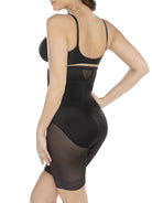 a woman wearing a black high waisted sheer shapewear short body shaper