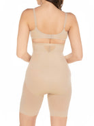 a woman wearing a nude high waisted sheer shapewear short body shaper
