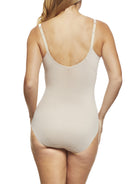 a woman wearing a beige shaping bodysuit