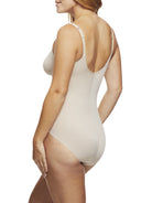 a woman wearing a beige shaping bodysuit
