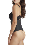 a woman wearing a black tummy control underwear thong