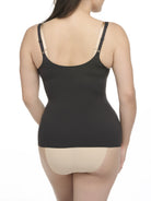 woman wearing a black open bust camisole with a beige bra