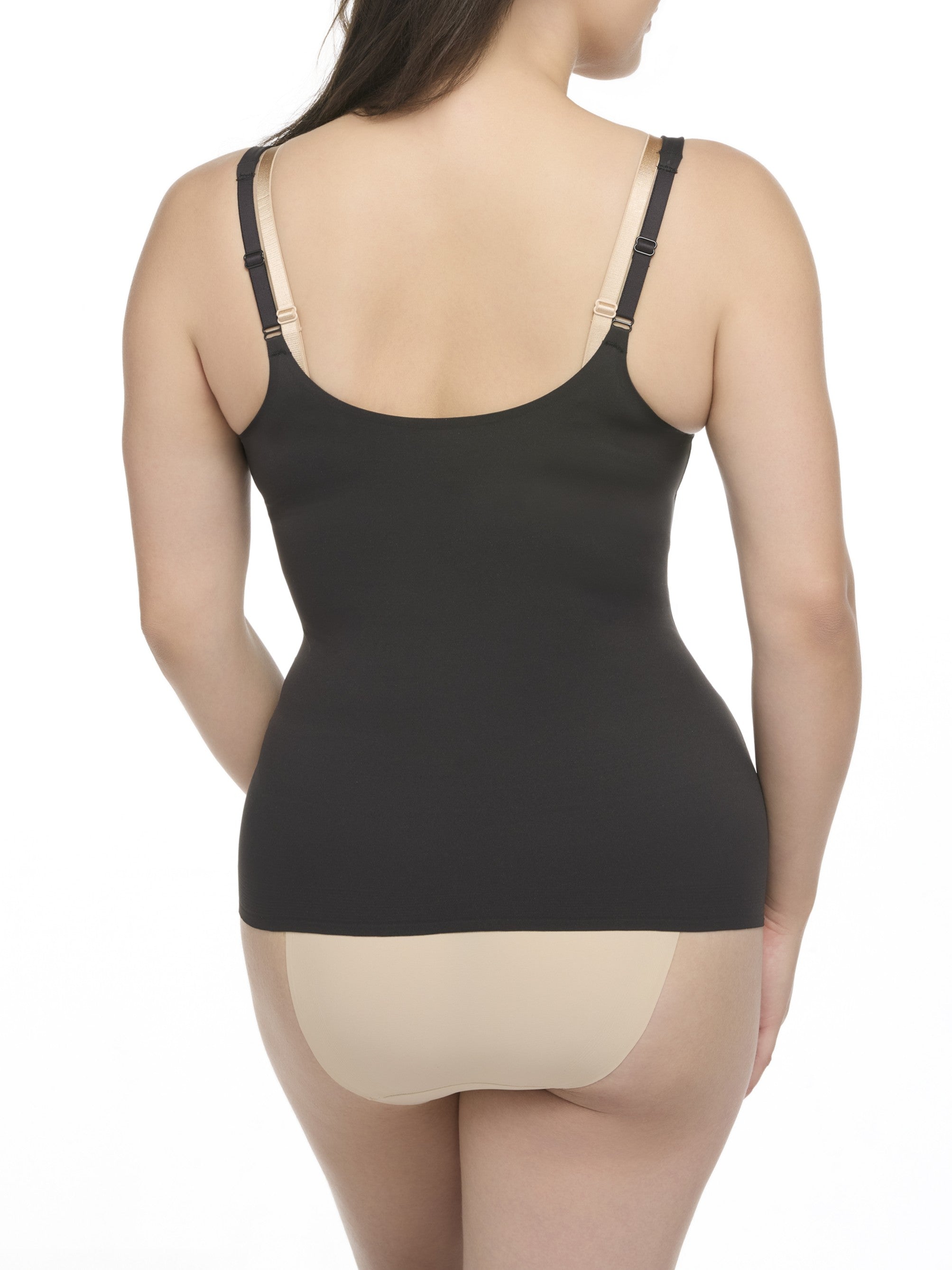 woman wearing a black open bust camisole with a beige bra