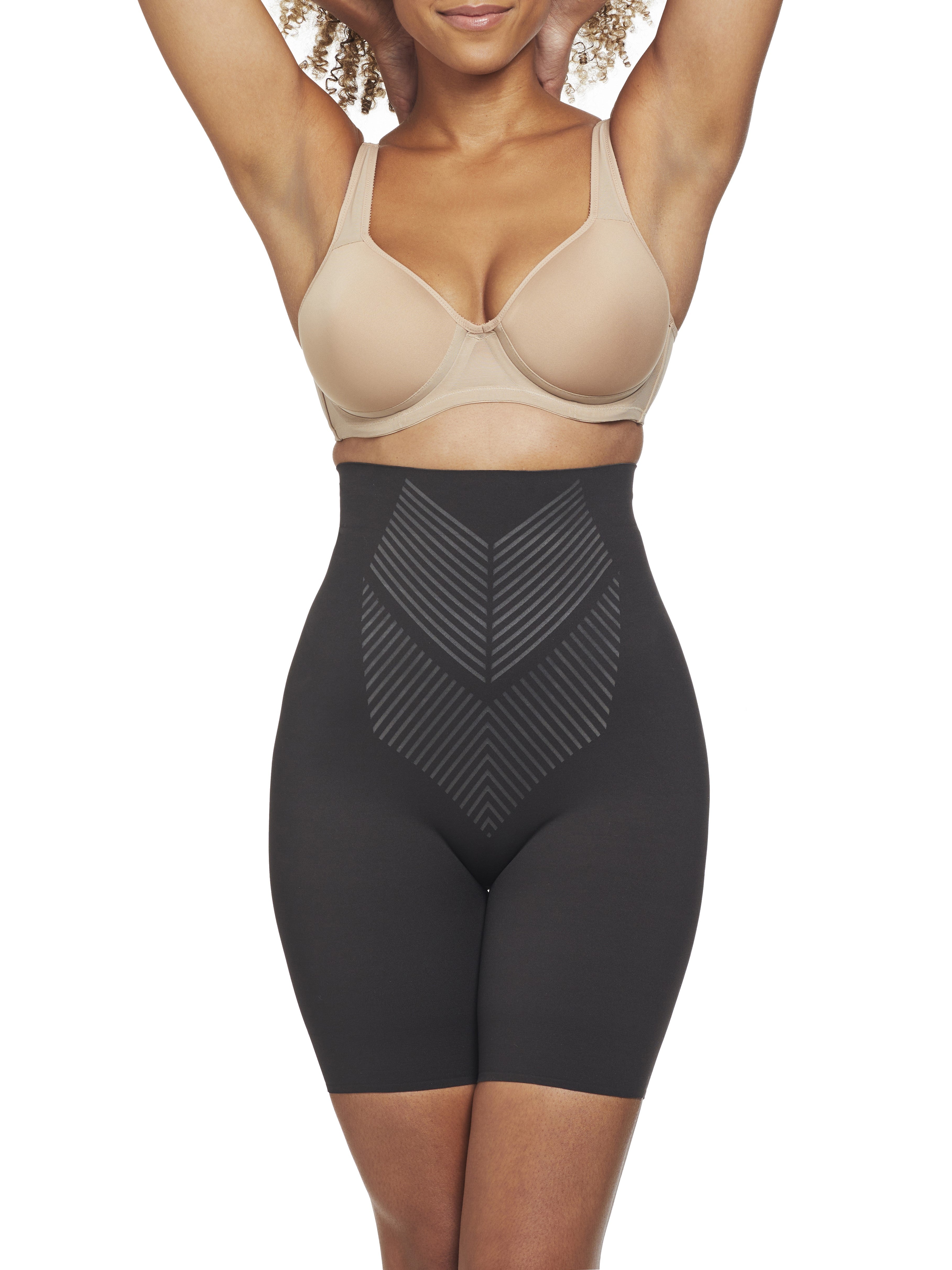 a woman wearing a black high waisted tummy control shapewear short