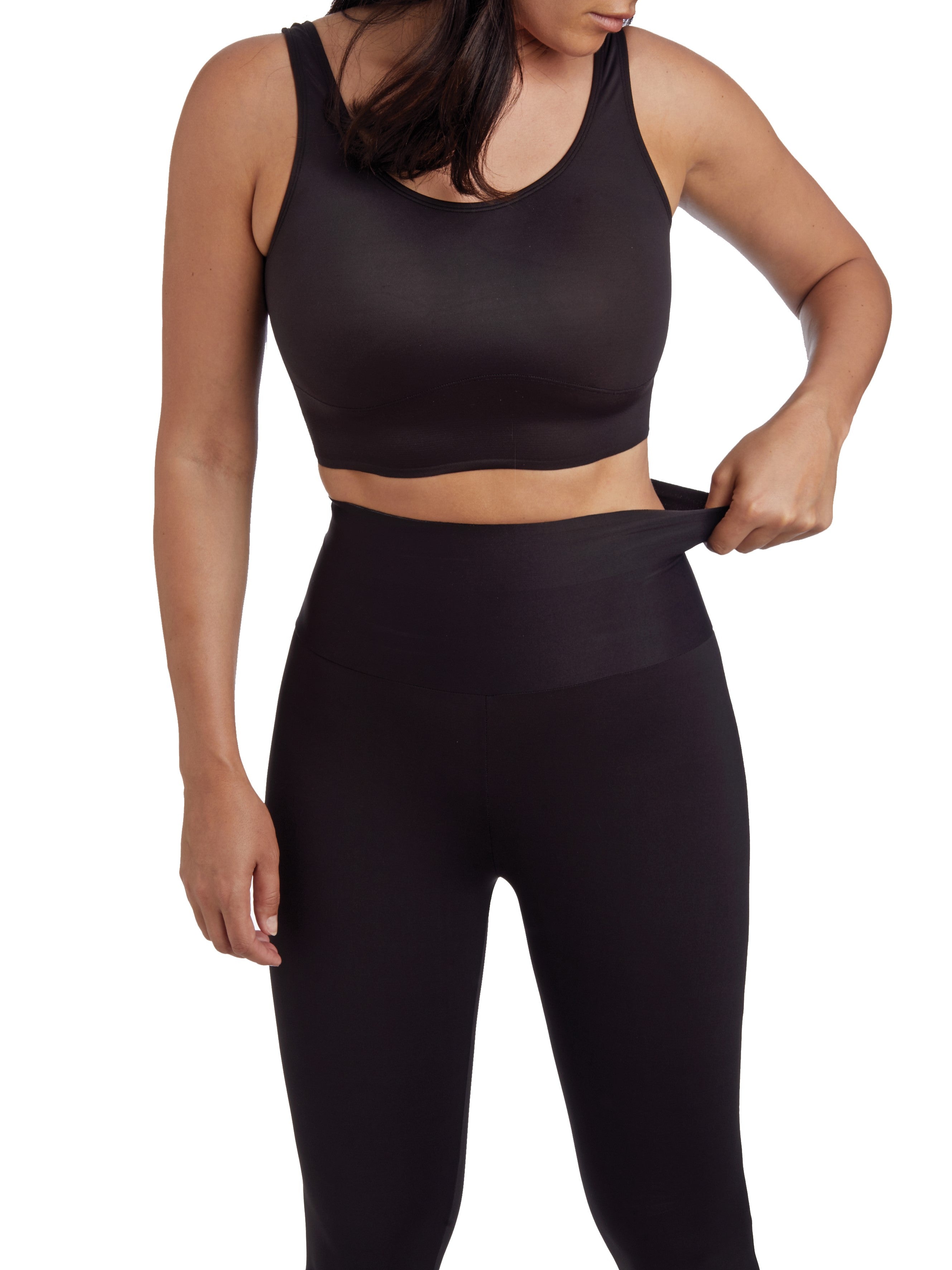 a woman wearing black tummy control leggings shapewear