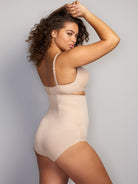 a woman wearing a nude high waisted control top panty shapewear all-groups