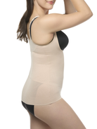 Woman wearing a beige shaping cami with black bra and underwear on a white background