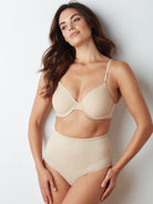 a woman wearing nude tummy control underwear shapewear