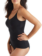 a woman wearing a black tummy control shaping camisole shapewear