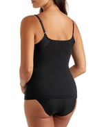a woman wearing a black tummy control shaping camisole shapewear