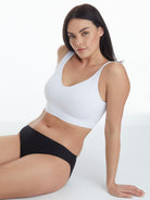 a woman sitting down wearing a wirefree bra all-groups