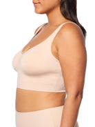 a woman wearing a nude bralette