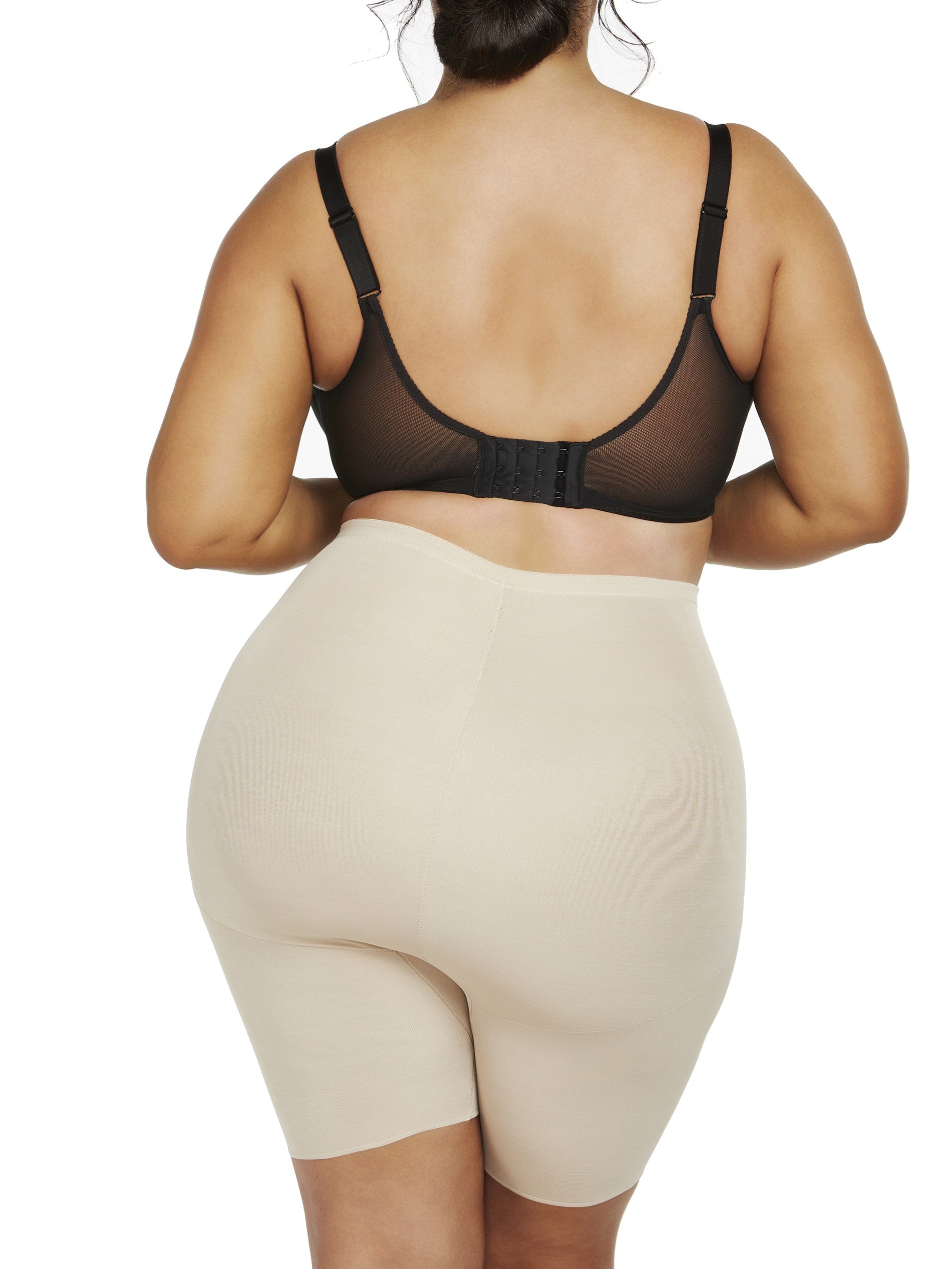 a woman wearing nude plus size tummy control shapewear shorts