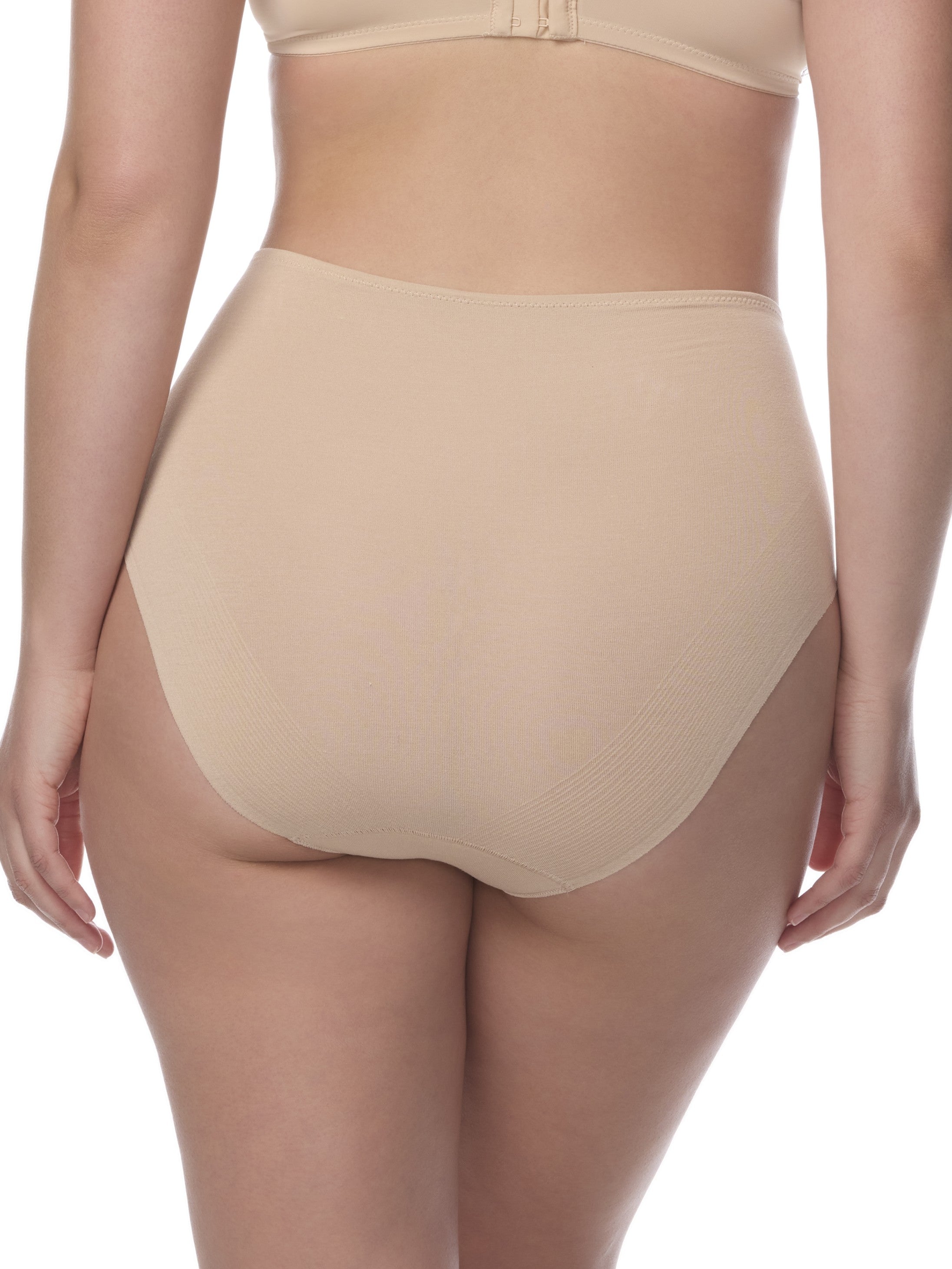 Beige underwear being worn by a person on a white background