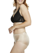 a woman wearing a beige shaping brief