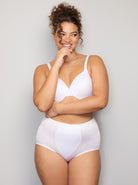 a woman wearing a white control top panty shapewear all-groups