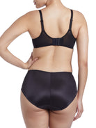 a woman wearing black tummy control underwear with high cut legs