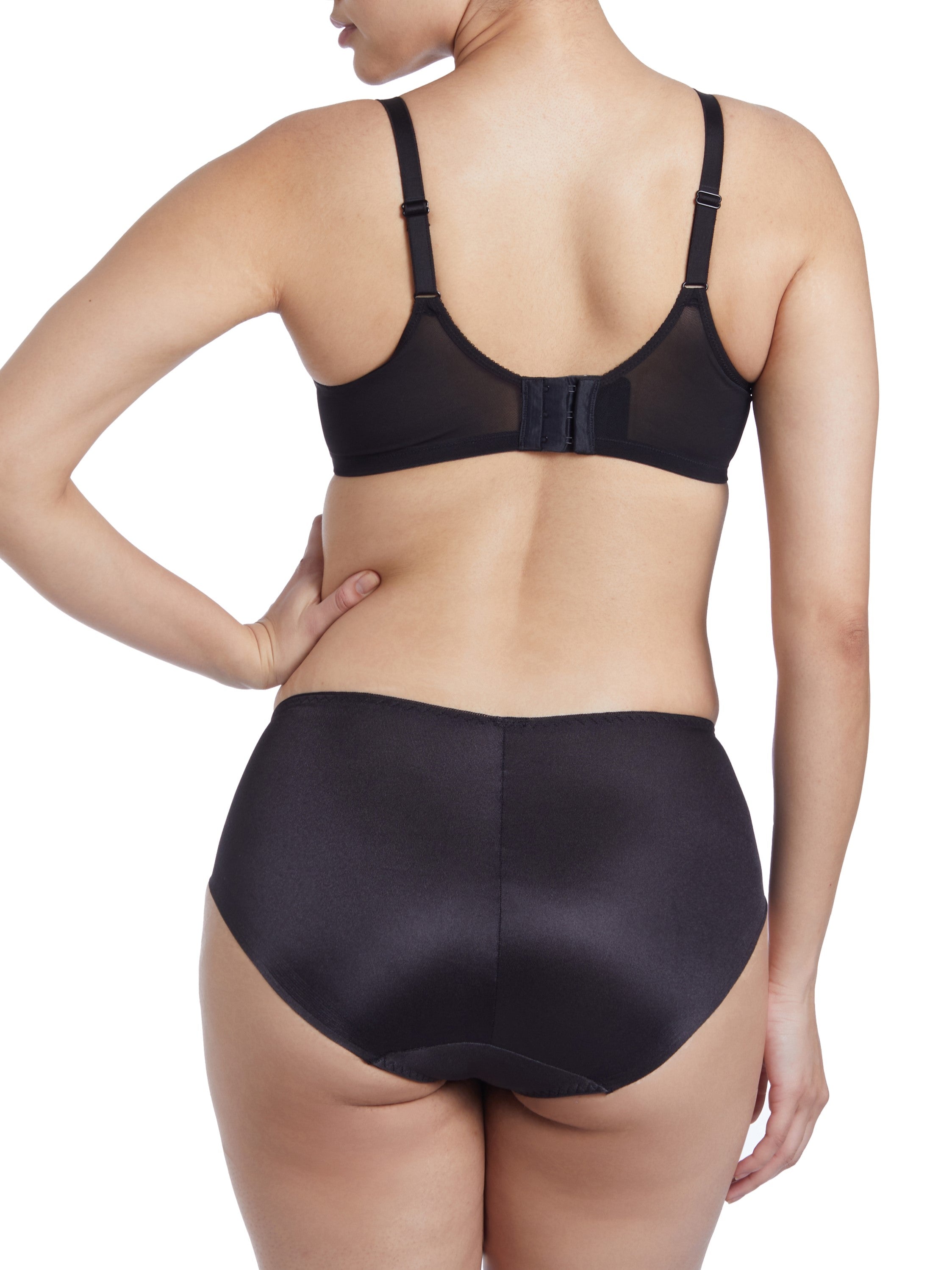 a woman wearing black tummy control underwear with high cut legs