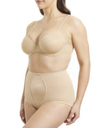 a woman wearing a beige shaping brief