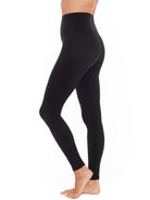 a woman wearing black tummy control leggings