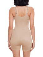 a woman wearing a beige open-bust shaping bodysuit romper