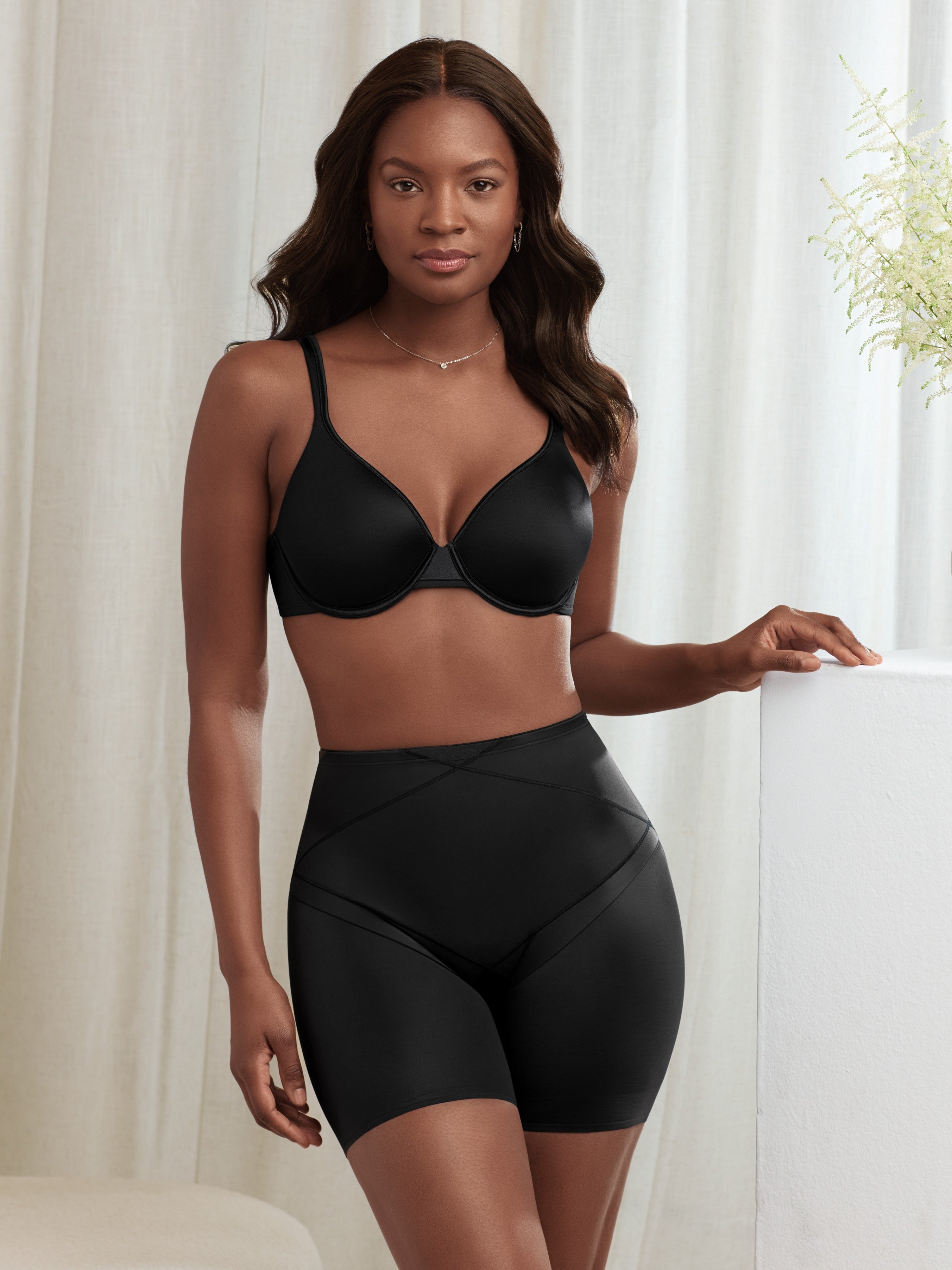 a woman wearing a black tummy control panty short