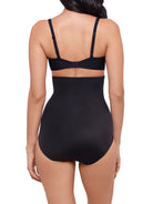 a woman wearing a black high waisted tummy control brief shapewear