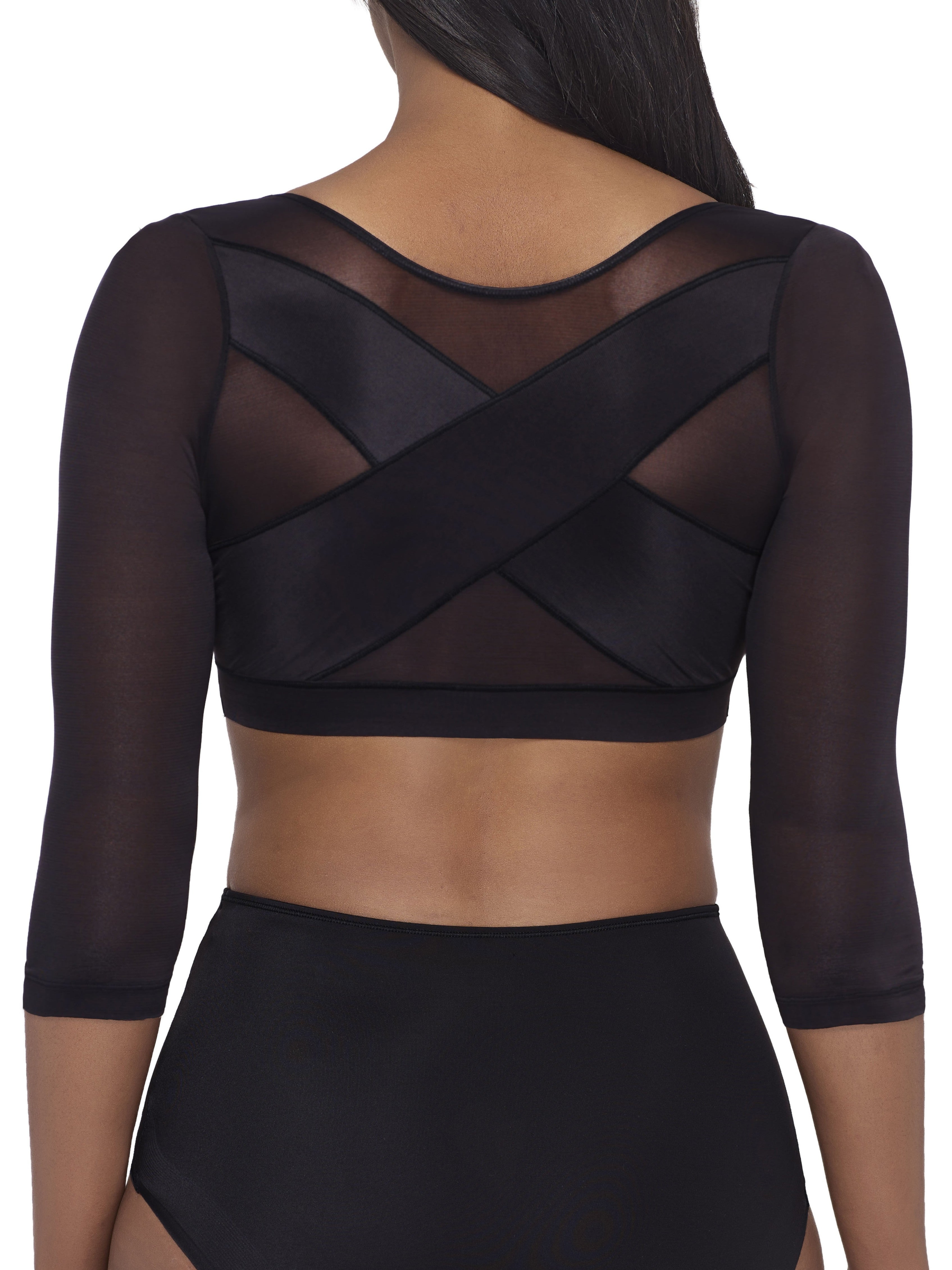 a woman wearing a black back and arm smoothing cami shapewear