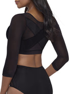 a woman wearing a black back and arm smoothing cami shapewear