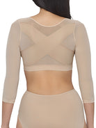 a woman wearing a beige back and arm smoothing cami shapewear