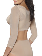 a woman wearing a beige back and arm smoothing cami shapewear