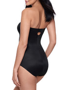 a woman wearing a black strapless shapewear bodysuit total body shaper