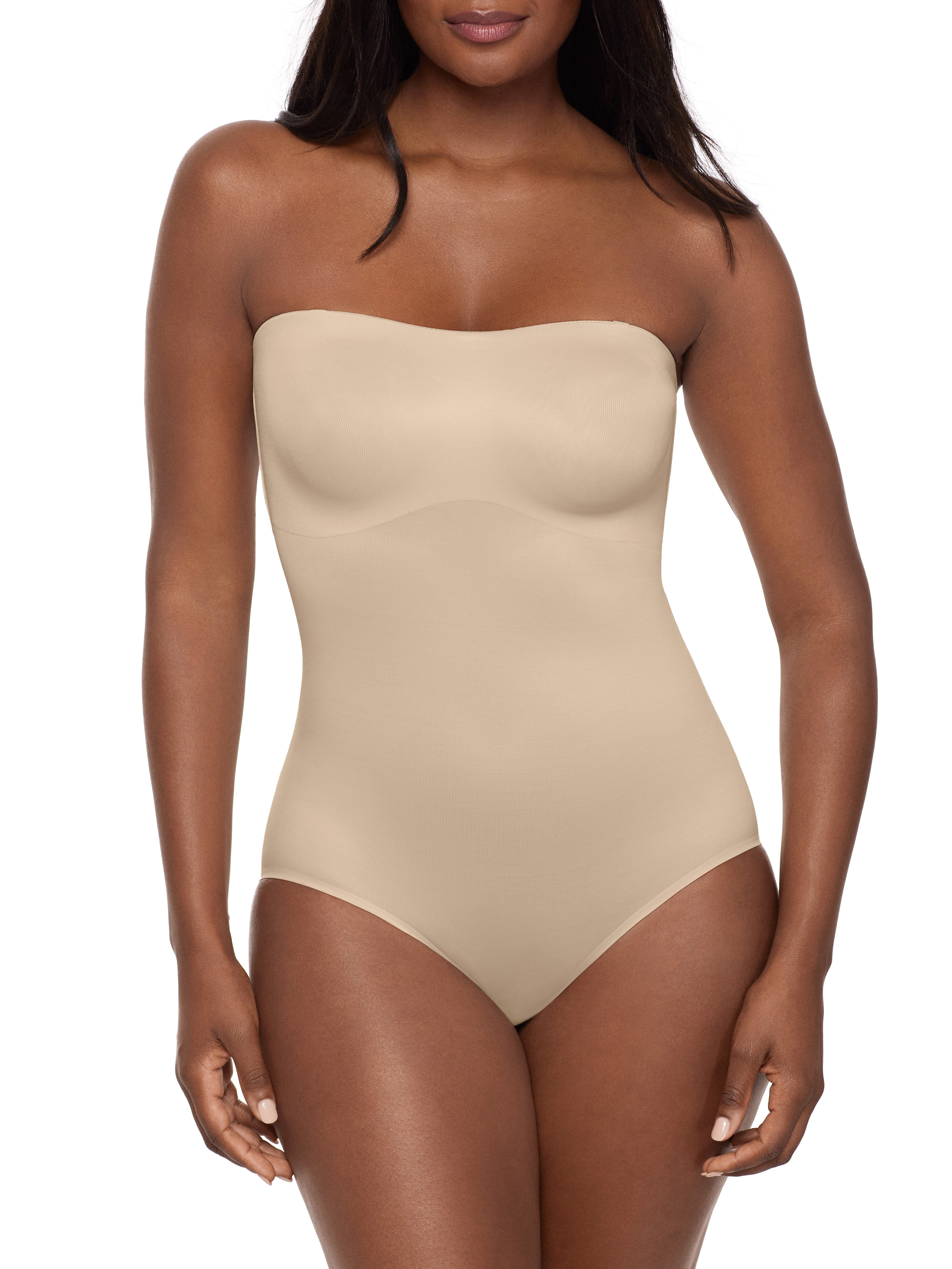 a woman wearing a beige strapless shapewear bodysuit total body shaper
