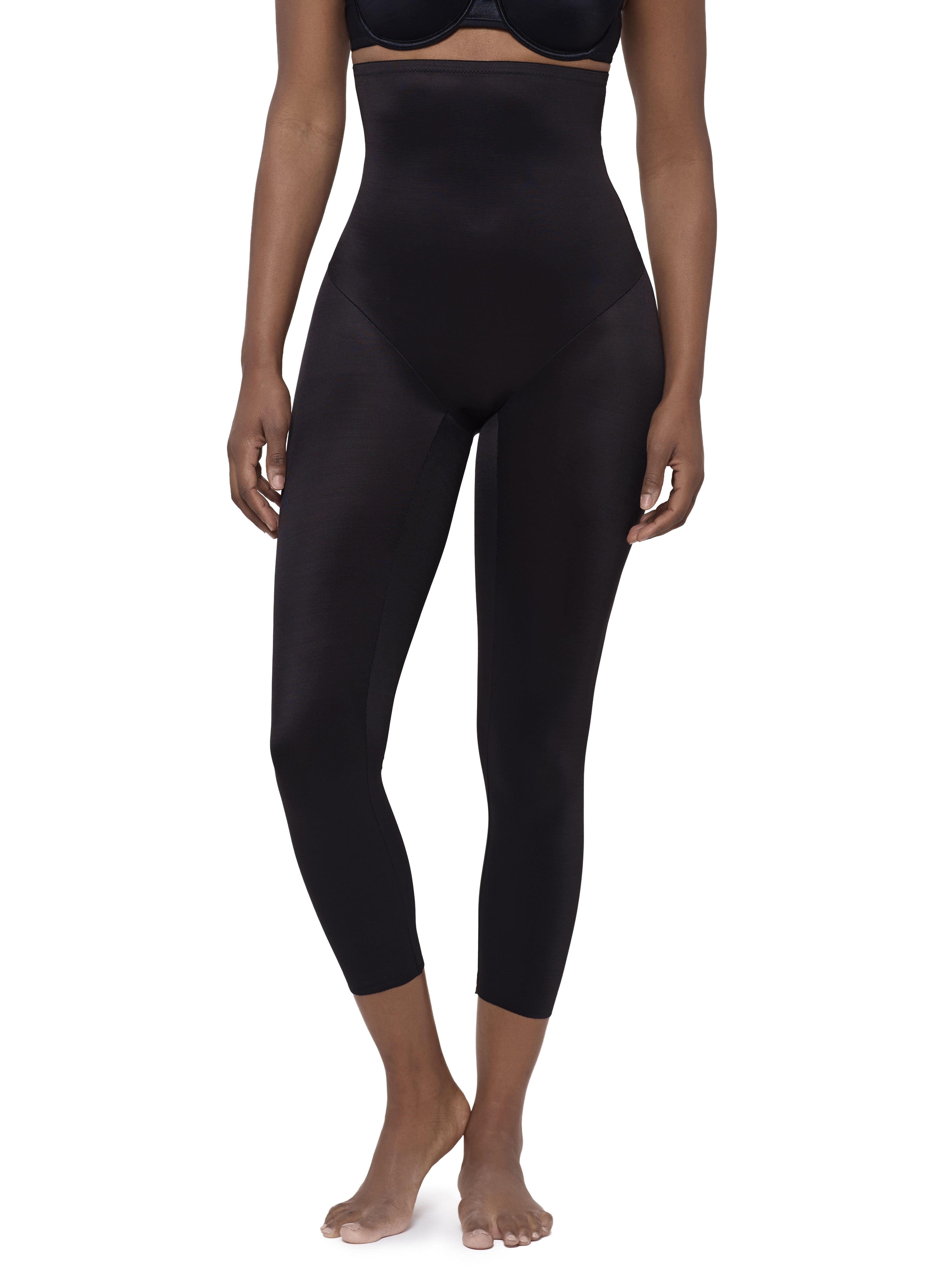 Black high-waisted shapewear capri leggings shown on a model against a plain white background.