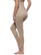 A side profile view of a model wearing high-waisted, mid-calf compression leggings in a light beige shade against a plain white background.
