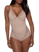 Beige lace bodysuit worn by a model on a white background
