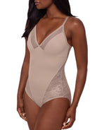 Beige bodysuit worn by a model on a white background