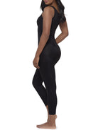 A woman modeling a full-body black shaper bodysuit or against a plain white background.