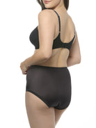Woman wearing a black bra and shapewear brief set on a white background