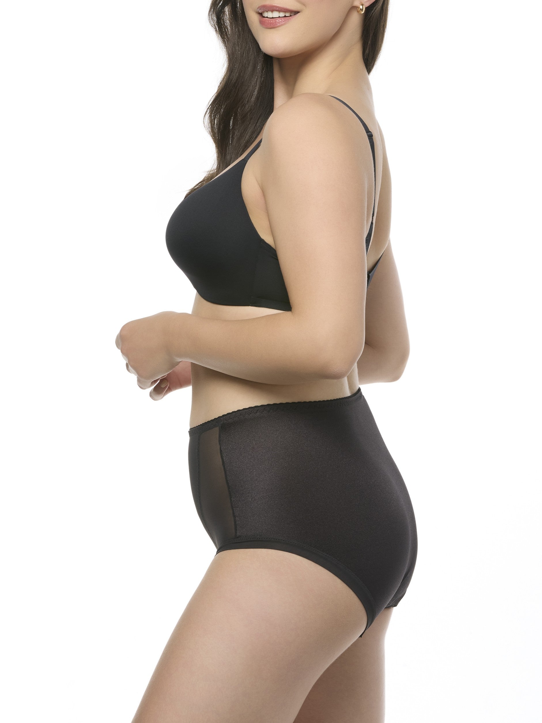Woman wearing a black bra and shapewear brief set on a white background