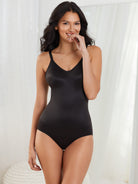 a woman wearing a black shaping bodysuit all-groups