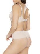 a woman wearing a beige shaping thong