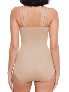 a woman wearing a beige open-bust shaping bodysuit